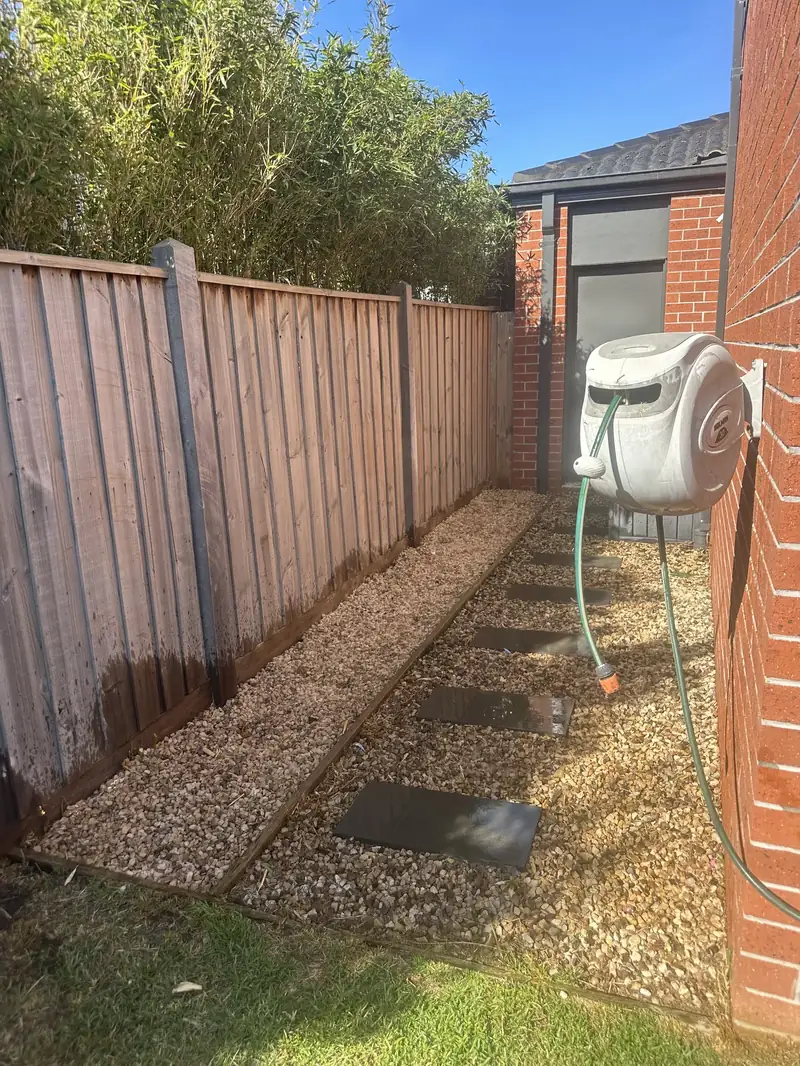 Side passage with timber decking and pebble bed, tidied by C&J